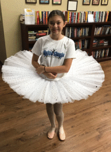 Miss Valerie finished blinging Mia's tutu. Mia models it in ballet shoes and tee shirt - such a true dancer